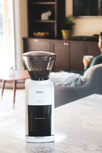 Load image into Gallery viewer, A Baratza Encore Grinder in a home with a guy drinking coffee.