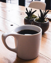 Load image into Gallery viewer, A Coffee Mug with a dark roast coffee from ethiopia
