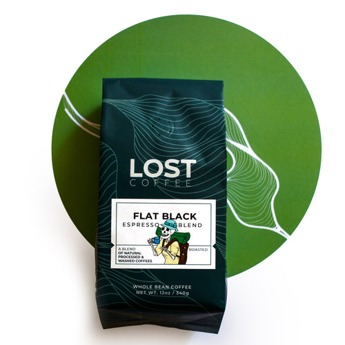 Flat Black Espresso Blend in a green bag, a natural and washed process whole bean